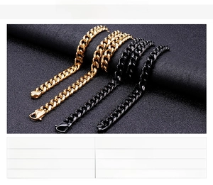 Close-up of gold and black chunky Cuban chain necklaces set in stainless steel