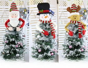 Detail view of plush Christmas tree toppers featuring Santa, Snowman and Reindeer styles