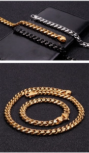 Macro shot of gold, silver, and black cuban link necklaces on premium black leather