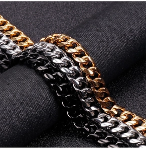 Macro shot of Cuban link bracelets in gold, silver, and black polished stainless steel