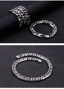 Macro detail of polished stainless steel curb chain bracelet for men with metallic luster