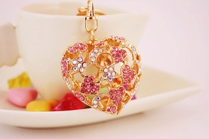 Detailed view of golden heart-shaped keychain with colorful rhinestones and lobster clasp