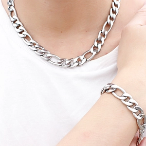 Men's silver Figaro chain necklace and bracelet set shown on model for a classic look
