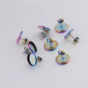 Macro view of iridescent multi-color stainless steel earring bases and butterfly backs