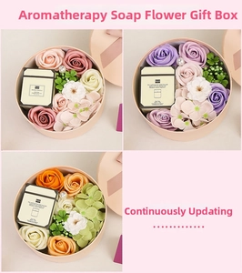 Detail of soap flower gift set with mini scented candle in round pink and orange boxes