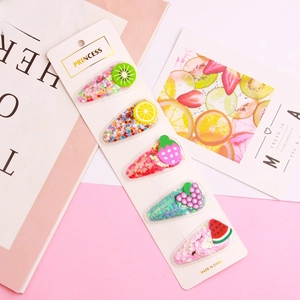 Set of 5 glittery fruit-themed snap hair clips for kids on a princess display card