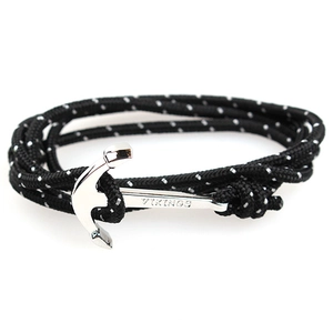 Detail of black woven rope bracelet with silver anchor pendant and VIKINGS engraving