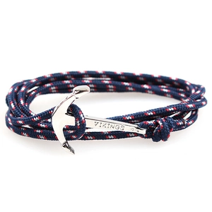 Macro detail of nautical rope bracelet with silver anchor clasp and Vikings engraving