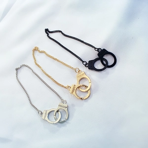 Three-piece handcuff bracelet set in black, gold, and silver with Freedom engraving