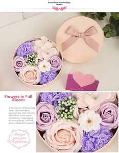 Detail of purple rose soap flower arrangement in a round gift box with pink bow
