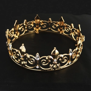Detailed view of ornate gold bridal crown featuring white crystals and vintage motifs