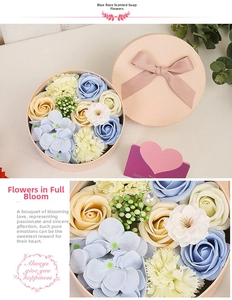 Detail of blue soap flower bouquet in round gift box with pink ribbon and heart card