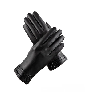 Detail of black leather gloves with decorative stitching and a wrist button accent
