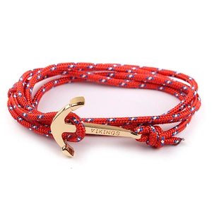 Close-up of red nylon rope bracelet with gold anchor clasp and Vikings engraving