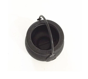 Top view of a black mini Halloween cauldron with textured surface and round handle