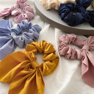 Detail shot of textured chiffon scrunchies with long bow ribbons in pastel colors