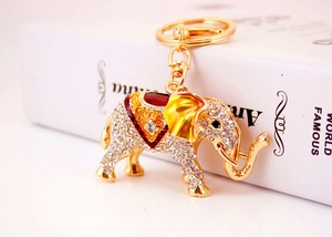 Close-up of golden elephant keychain with sparkling rhinestones and colorful enamel details