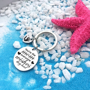Stainless steel Mother's Day keychain with engraved heart pendants on seaside decor