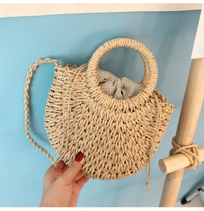 Handmade straw woven round bag for women, summer beach tote with top handle and strap.