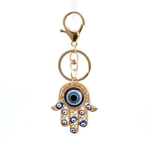 Golden Hamsa Hand Evil Eye keychain with blue protective charms and crystals