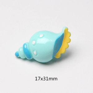Blue resin seashell charm with yellow edge for DIY crafts, 17x31mm detail view