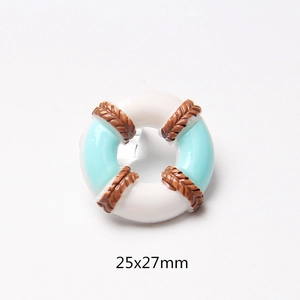 Macro view of blue and white nautical lifesaver resin charm measuring 25x27mm for DIY crafts