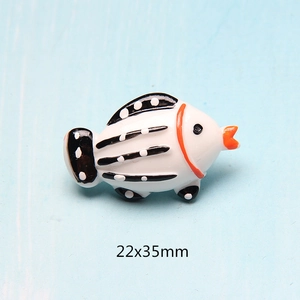 Macro view of a 22x35mm striped resin fish charm for DIY phone case crafts