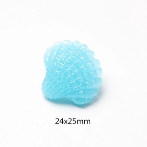 Detail of light blue resin shell charm with silver glitter and 24x25mm size markings