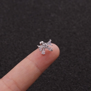 Detailed view of silver bow stud earring with zircons and screw back closure