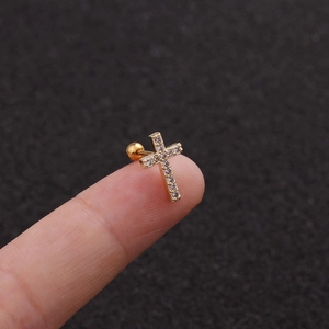 Macro shot of gold-plated cross stud earring with micro-pave zircons and screw back