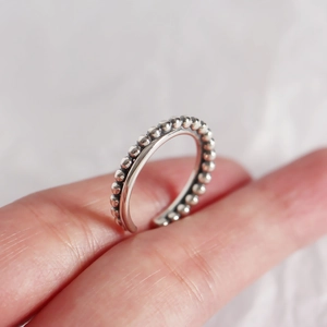 Macro shot of S925 sterling silver beaded cross ring with adjustable open band detail