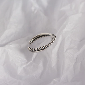 Macro detail showing the S925 hallmark on the minimalist silver beaded open ring band