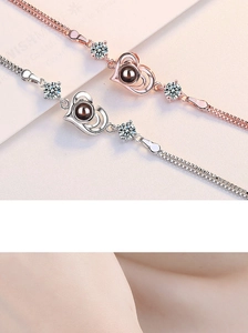 Macro detail of heart projection bracelet featuring shiny zircons and rose gold finish