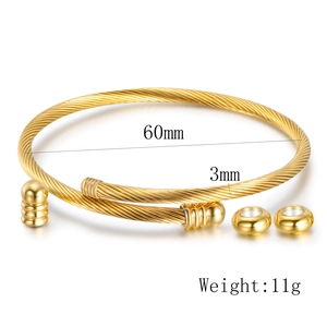 Detail view of gold twisted wire bangle with 60mm inner diameter and ball ends