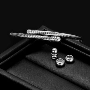 Macro shot of silver stainless steel cable twist bracelet with three movable beads