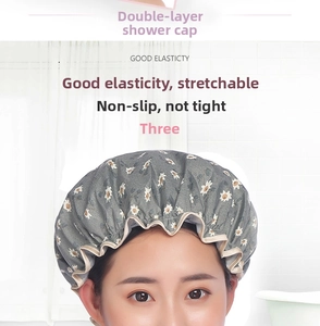 Detail of double-layer waterproof shower cap with daisy print and elastic champagne edge