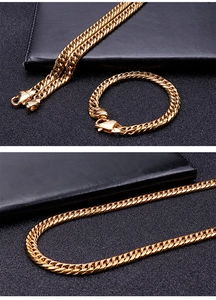 Detail view of 9mm gold stainless steel curb chain necklace and bracelet with lobster clasp