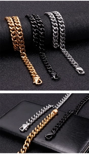 Close-up of polished gold, black, and silver Cuban link chains with secure lobster clasps