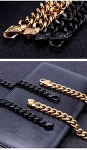 Detail of gold and black Cuban link chains in various thicknesses on black leather