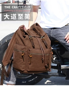 Brown vintage canvas backpack with leather straps shown in a rugged outdoor setting