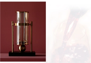 Macro detail of luxury gold metal wine decanter with transparent glass and black base