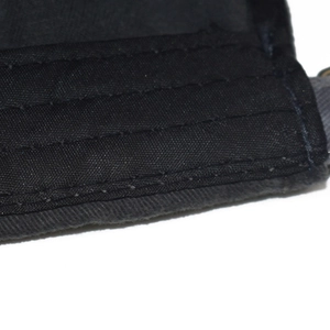 Detailed close-up of triple-stitched seams on a black vintage washed cotton baseball cap
