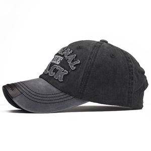 Detailed view of embroidery lettering and distressed washed cotton on baseball cap