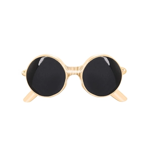Detail of vintage round black sunglasses with a gold metal frame and double bridge design
