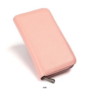 Side view showing the lychee grain leather texture and metallic zipper of the pink wallet