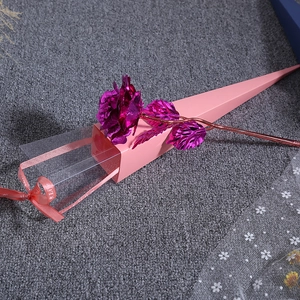 Detailed view of purple 24K gold foil rose inside a pink gift box with ribbon decoration