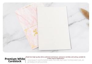 Detail of pink marble card with gold foil text and premium paper texture