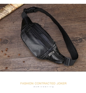 Close-up of a black waterproof leather waist bag with three zipper pockets on a wooden desk
