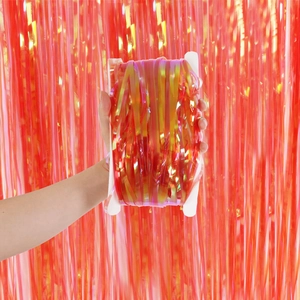 Close-up of rainbow foil fringe curtain roll with vibrant orange and gold laser finish