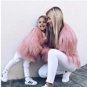 Detailed texture of pink faux fur coat on girls showing the soft long-fiber plush material